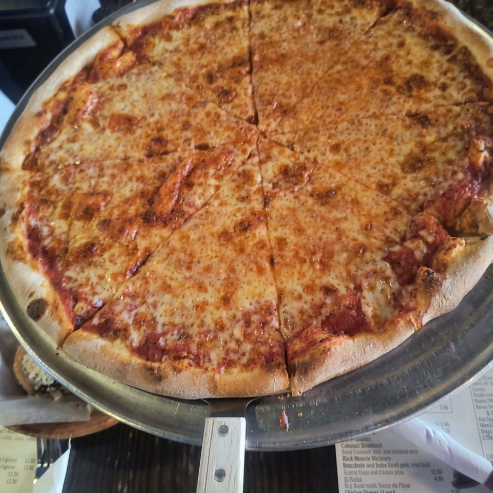Golden cheese pizza on a metal tray.